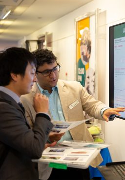 two students consulting a screen