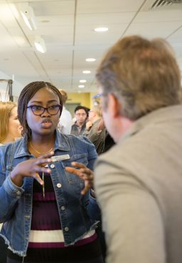 Student gesturing while talking to another student